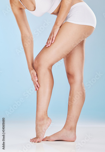 Woman, legs and skincare moisturizer of a model using lotion, cream and skin leg treatment. Beauty, cosmetic and well being health care of a person touching a body to feel smooth hair laser treatment