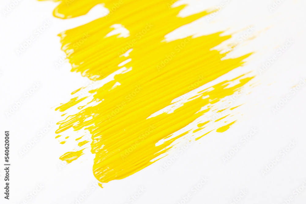 White background with bright yellow paint smear