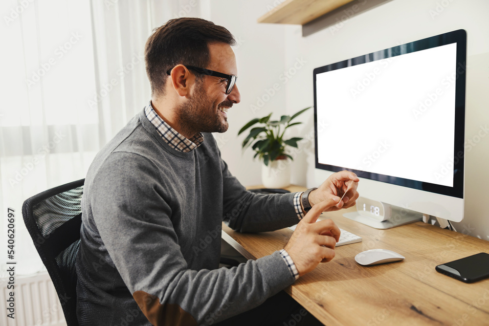 An elegant man sits at home office and purchasing online on web shop. An elegant man sits at home office and purchasing online on web shop.
