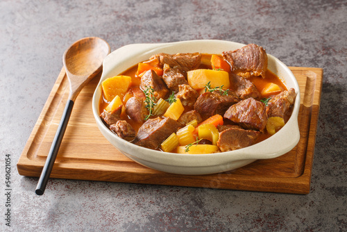 Traditional Irish Stew featuring succulent lamb, sweet root vegetables, and an irresistibly rich broth closeup in the pot on the table. Horizontal