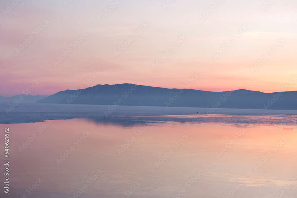 Beautiful sunset on frozen lake Baikal. Winter landscape. Beautiful sunset on frozen lake Baikal. Winter landscape.
