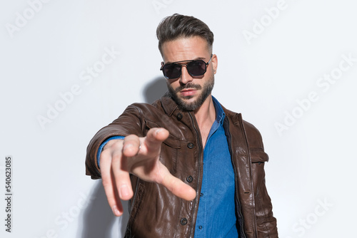 Attractive casual man dominating the frame with one arm