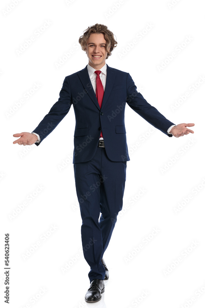 young guy with curly hair wearing suit, opening arms and welcoming young guy with curly hair wearing suit, opening arms and welcoming
