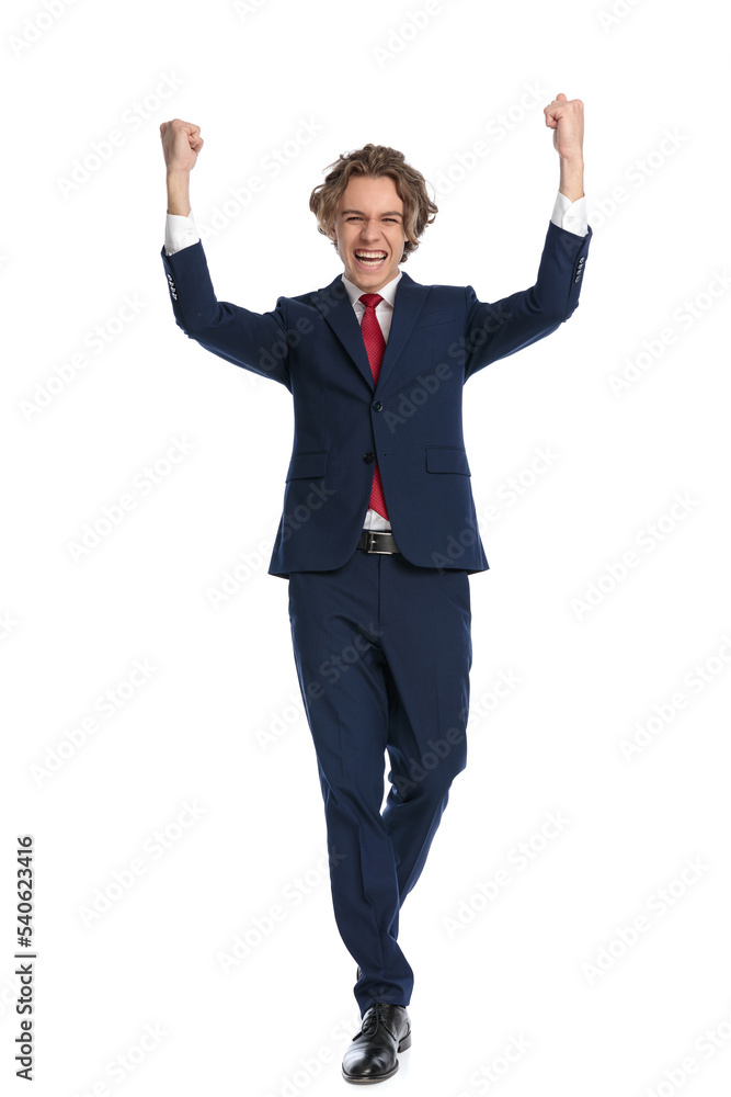 man with curly hair holding fists above head and celebrating victory man with curly hair holding fists above head and celebrating victory