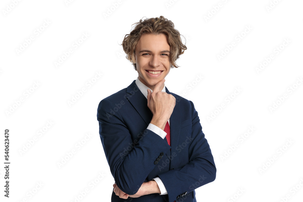 happy young businessman with curly hair touching chin and smiling happy young businessman with curly hair touching chin and smiling