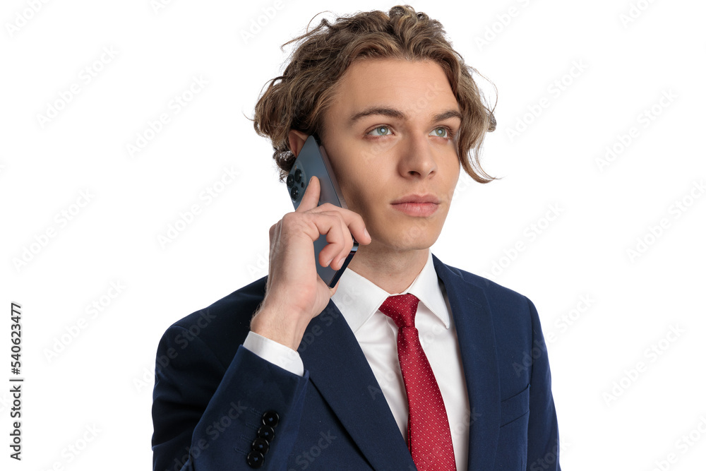 elegant businessman with blue eyes looking up while talking on the phone elegant businessman with blue eyes looking up while talking on the phone