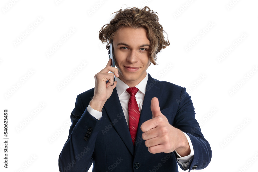 happy businessman having a conversation on the phone and making thumbs up sign happy businessman having a conversation on the phone and making thumbs up sign
