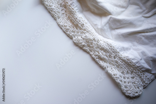 Crocheted vintage underwear on a white background. Vintage fabric items.Lace bed linen of the last century.