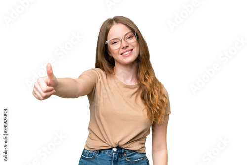 Young pretty woman over isolated background with thumbs up because something good has happened