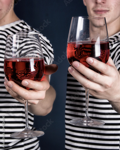 Holidays. A beautiful couple is drinking red wine.