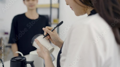 Startup successful small business owner sme woman, beauty girl white name on paper cup in coffee shop restaurant. Portrait of asian woman barista cafe owner. SME entrepreneur niche market seller