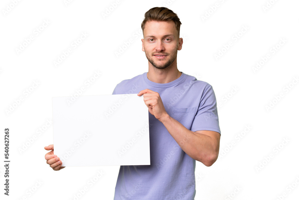 Young blonde caucasian man over isolated background holding an empty placard with happy expression Young blonde caucasian man over isolated background holding an empty placard with happy expression