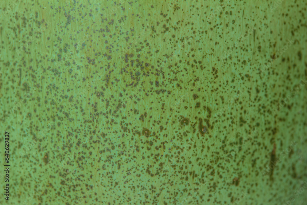 Abstract texture background of a macro photographed glazed ceramic stoneware surface in the color of lime green Abstract texture background of a macro photographed glazed ceramic stoneware surface in the color of lime green