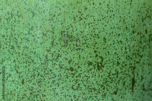 Abstract texture background of a macro photographed glazed ceramic stoneware surface in the color of mint green