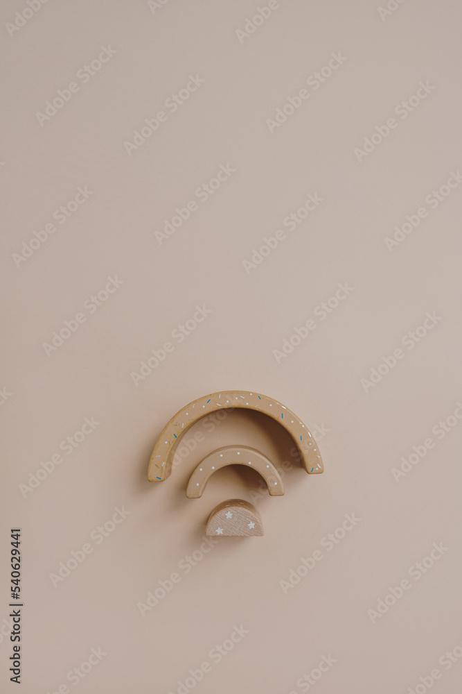 Rainbow stacking toy on neutral soft beige colour background. Flat lay, top view Rainbow stacking toy on neutral soft beige colour background. Flat lay, top view