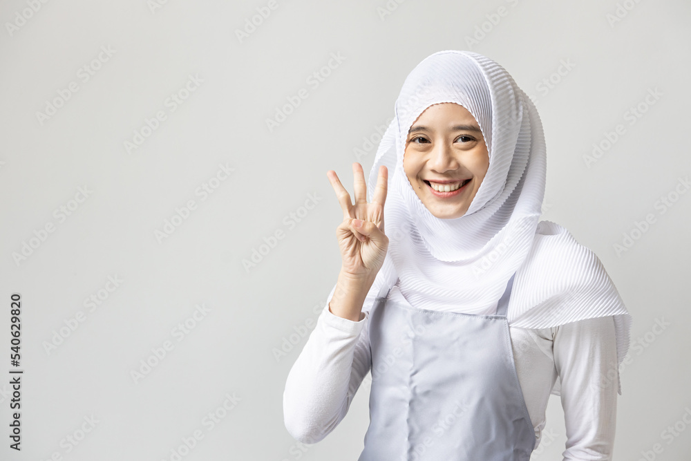 Confident happy smiling muslim woman catering business owner pointing up 3 fingers hand gesture Confident happy smiling muslim woman catering business owner pointing up 3 fingers hand gesture