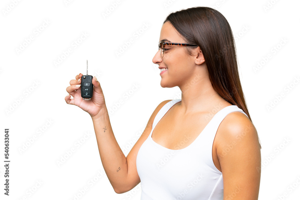 Young caucasian woman holding car keys isolated on green chroma background background with happy expression Young caucasian woman holding car keys isolated on green chroma background background with happy expression