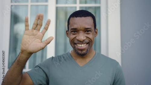 Portrait of young handsome black African man use smartphone selfie say hi in the nature park Happy afro guy online influencer blogger. Education technology connected people man lifestyle concept