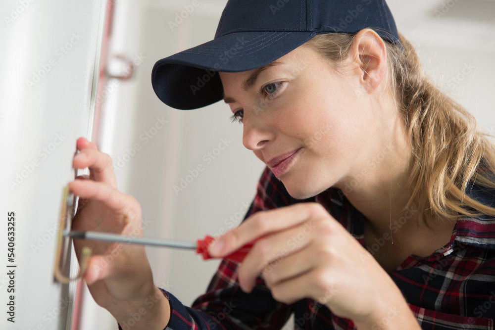 woman installing a hook