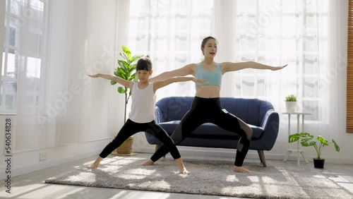 Portrait of young asian mother  daughter prepare for stretching post in yoga meditation. Mom and little girl toddler yoga exercise on yoga mat at home. Together lifestyle, Mother's Day concept