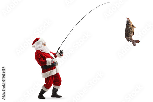 Foto Full length profile shot of santa claus with a carp fish on a fishing rod