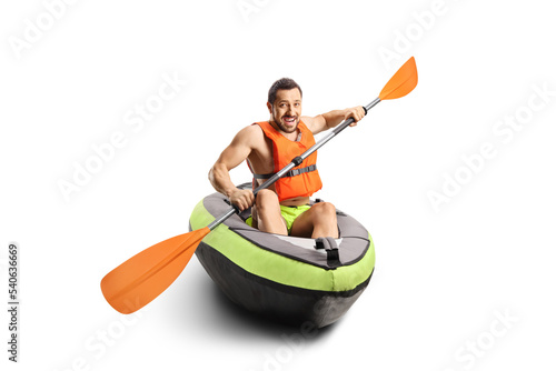 Smiling young man riding a canoe with a life vest photo