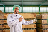worker presenting products on the production line in the beverage factory. Manufacturer checks quality of food industry.