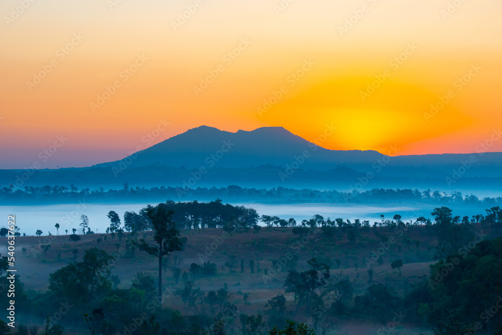 Aerial view sunrise over mountain with fog over the ground in foreground savannah Meadow , Petchaboon province, Thailand,asia.
