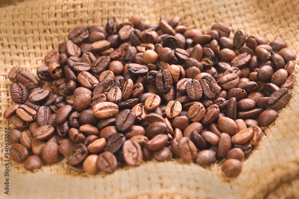 Coffee beans of medium roast coffee on on sackcloth. Arabica roast coffee beans. Toning drink, natural energetic. Beans closeup, coffee beans background. Espresso aroma, caffeine drink Coffee beans of medium roast coffee on on sackcloth. Arabica roast coffee beans. Toning drink, natural energetic. Beans closeup, coffee beans background. Espresso aroma, caffeine drink