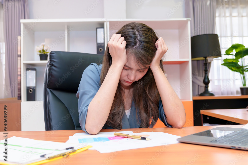 Young business people are suffering from headaches,Asian women Stressful Working with a notebook for a long time,Office syndrome concept Young business people are suffering from headaches,Asian women Stressful Working with a notebook for a long time,Office syndrome concept