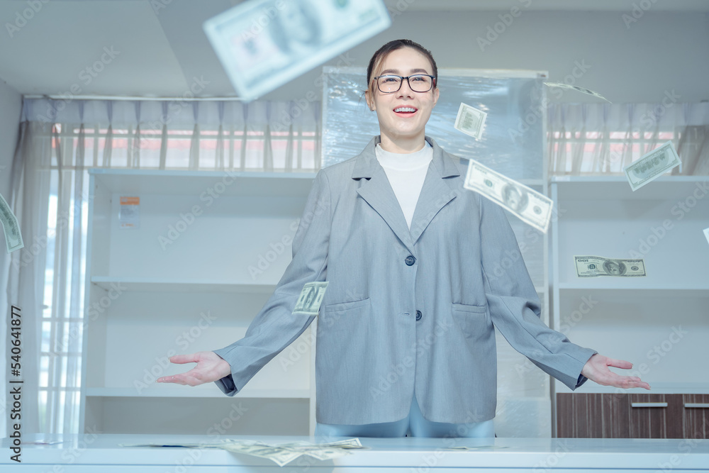 image of happy woman exults pumping fist happiness celebrating success under rain money falling dollar banknote isolated on gray wall background with copy space image of happy woman exults pumping fist happiness celebrating success under rain money falling dollar banknote isolated on gray wall background with copy space