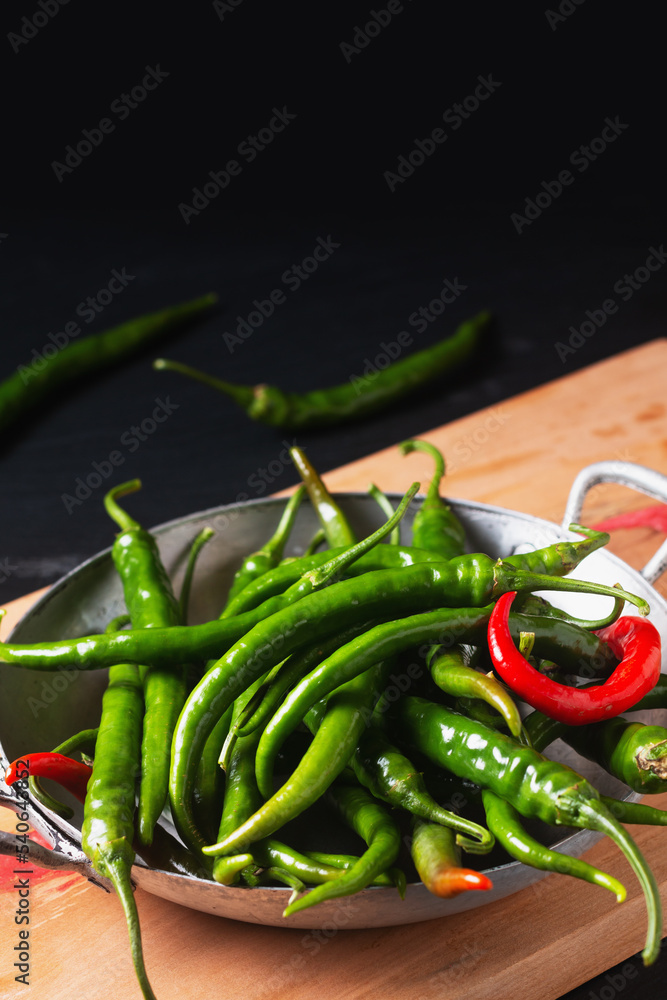 Organic food concept organic green cayenne peppers on black backrground with copy space