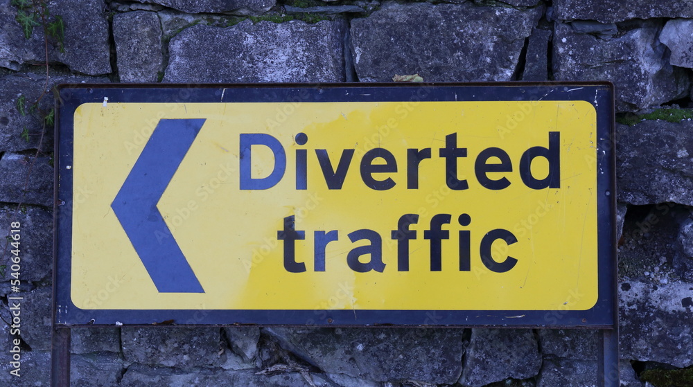 Road Sign for Diverted Traffic with arrowhead. Black lettering on yellow background. Road Sign for Diverted Traffic with arrowhead. Black lettering on yellow background.