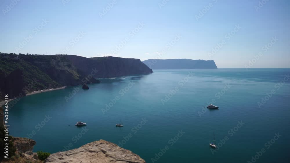 Aerial view from above on calm azure sea and volcanic rocky shores. Small waves on water surface in motion blur. Nature summer ocean sea beach background. Nobody. Holiday, vacation and travel concept Aerial view from above on calm azure sea and volcanic rocky shores. Small waves on water surface in motion blur. Nature summer ocean sea beach background. Nobody. Holiday, vacation and travel concept
