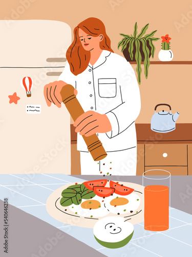 Girl cooking breakfast at home kitchen. Young woman in pajamas preparing morn...