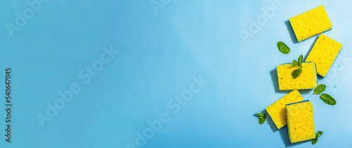 Bright yellow sponges for washing dishes. Organic cleaning concept, minty freshness