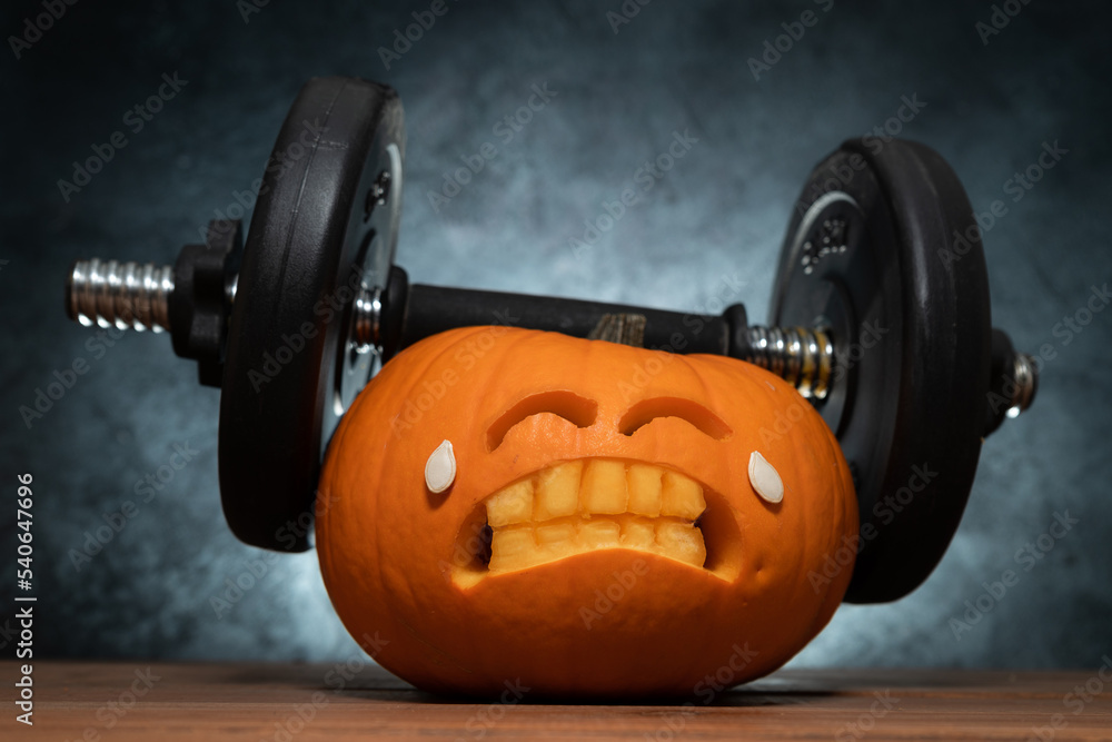 Carved Halloween Pumpkin Lifting A Heavy Barbell Dumbbell carved-halloween-pumpkin-lifting-a-heavy-barbell-dumbbell