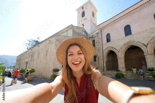 Smiling girl takes self portrait in Calabria with Tropea Cathedral  Calabria  Italy