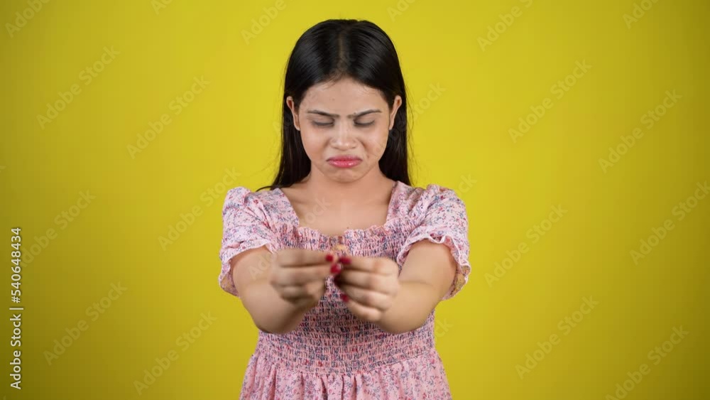 Depressed sad young woman holding ring in hand feeling upset disappointed frustrated unhappy regret mistake suffer from break up concept, isolated over yellow background Depressed sad young woman holding ring in hand feeling upset disappointed frustrated unhappy regret mistake suffer from break up concept, isolated over yellow background