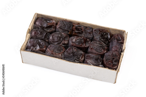 Soft date fruits in cardboard box on a white background