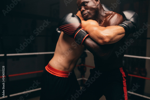 фотографія Male fighters fighting in a boxing ring