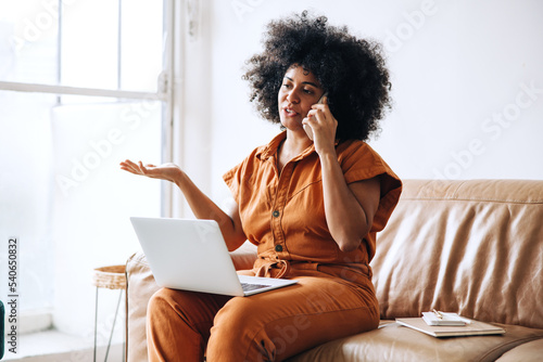 Young female entrepreneur speaking on the phone in an office