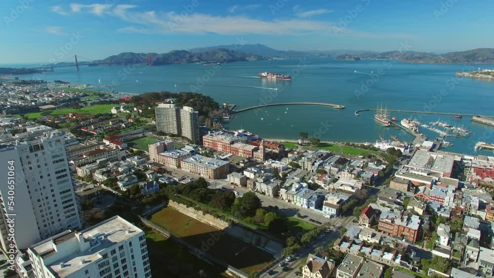 Aerial Shot Of Ships At Port In Residential City, Drone Flying Forward Over Buildings On Sunny Day - San Francisco, California Aerial Shot Of Ships At Port In Residential City, Drone Flying Forward Over Buildings On Sunny Day - San Francisco, California