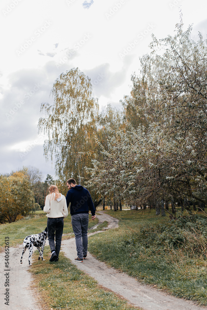 Couple Taking Dog For Walk In City Park Couple Taking Dog For Walk In City Park