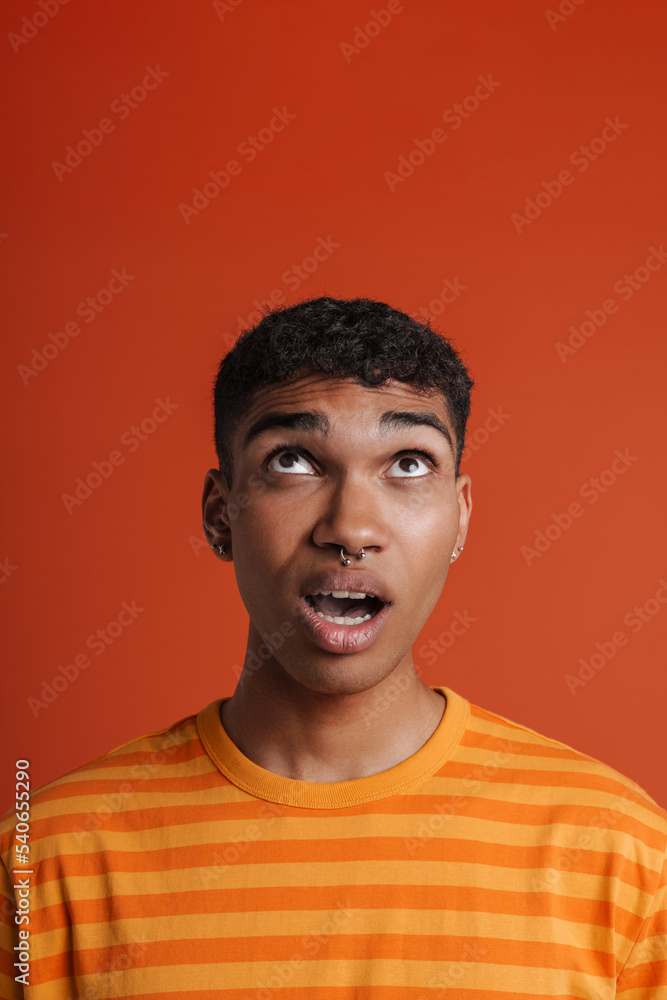 Young black man with piercing expressing surprise at camera Young black man with piercing expressing surprise at camera