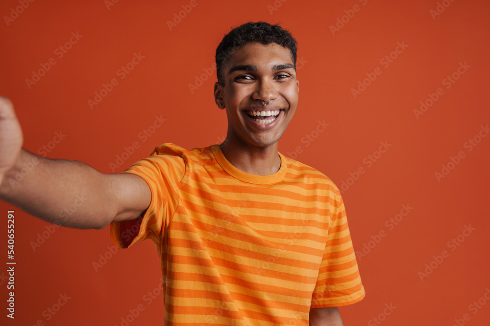 Selfportrait of young handsome smiling happy african man in t-shirt Selfportrait of young handsome smiling happy african man in t-shirt
