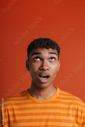 Young black man with piercing expressing surprise at camera