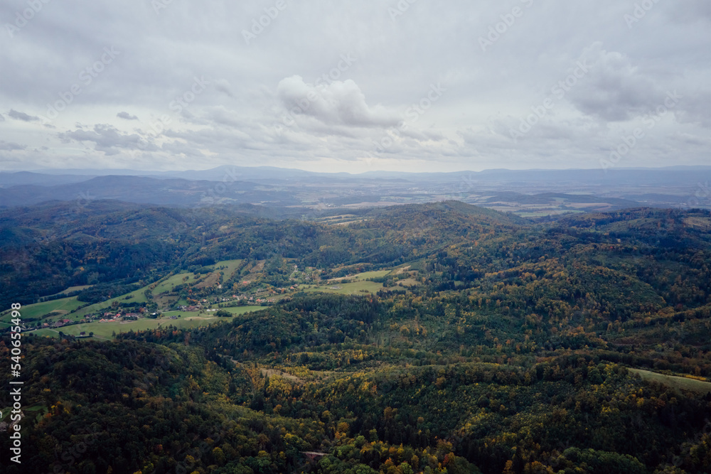 Drone flight over mountains covered with forest at autumn season. Mountain village, aerial view. Beautiful nature landscape Drone flight over mountains covered with forest at autumn season. Mountain village, aerial view. Beautiful nature landscape