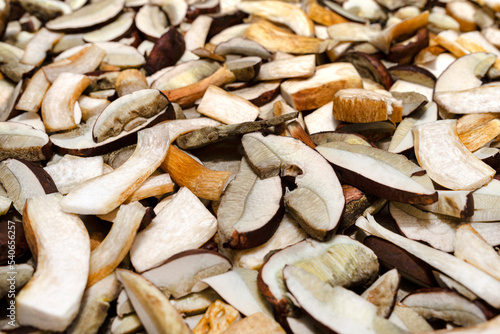 Background of sliced and raw edible mushrooms, lying on baking paper.