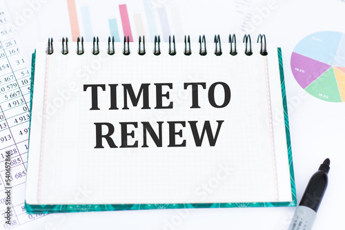 TIME TO RENEW text on notepad with pen, business